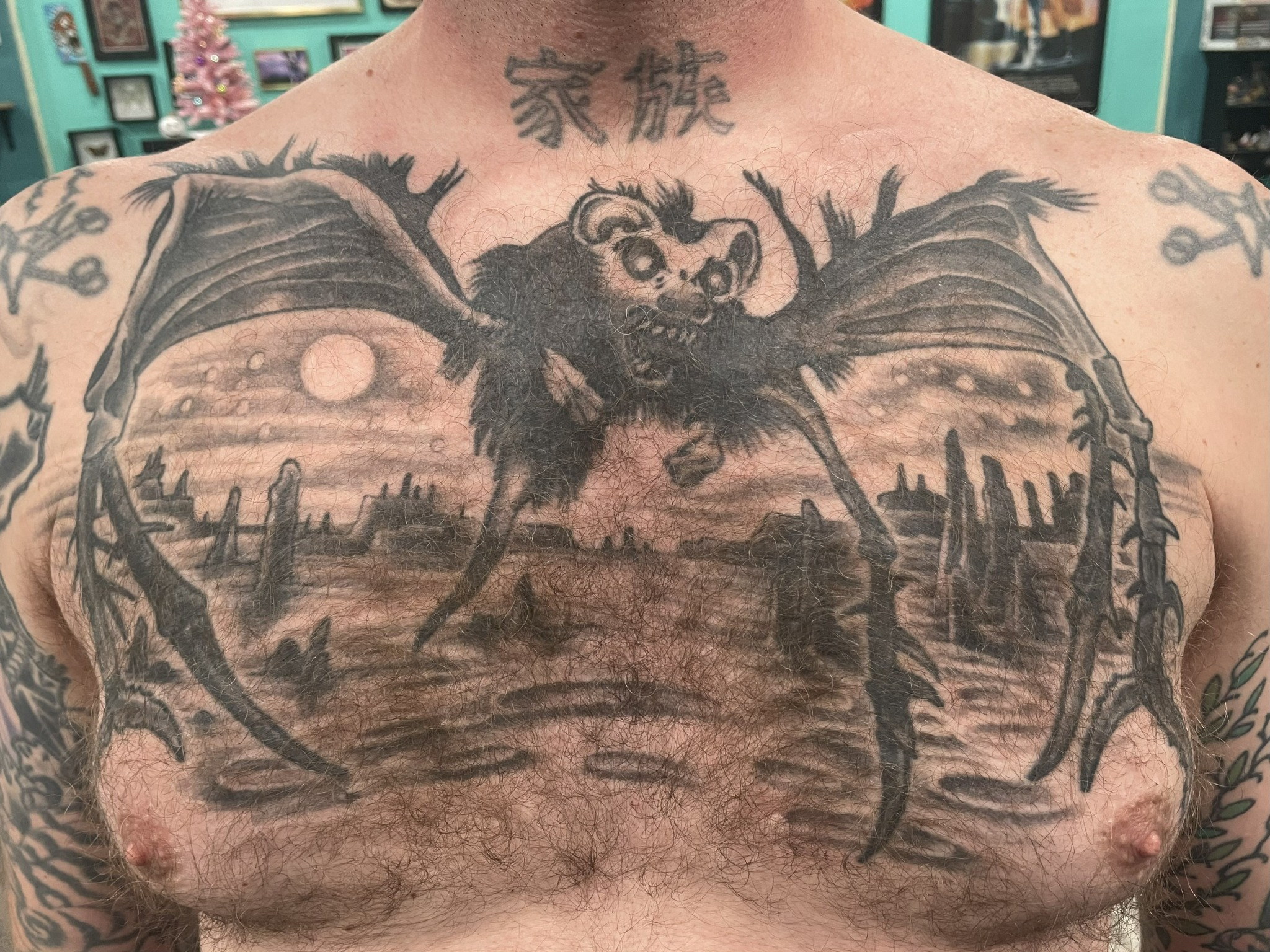 Black-and-gray bat creature chest tattoo by Dom at Last Hope Tattoo Company in Toledo