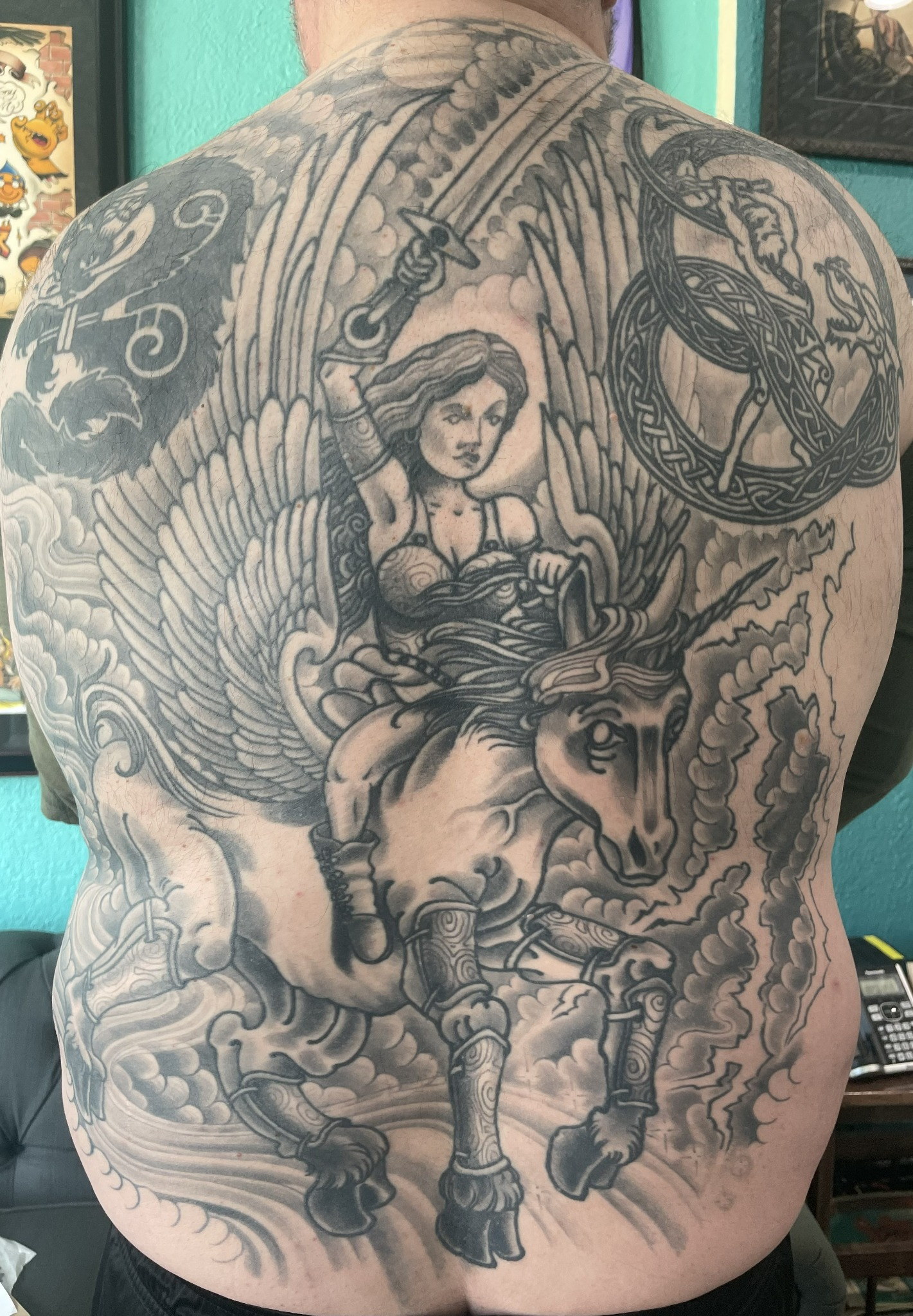 Black-and-gray winged horse back piece by Dom at Last Hope Tattoo Company in Toledo