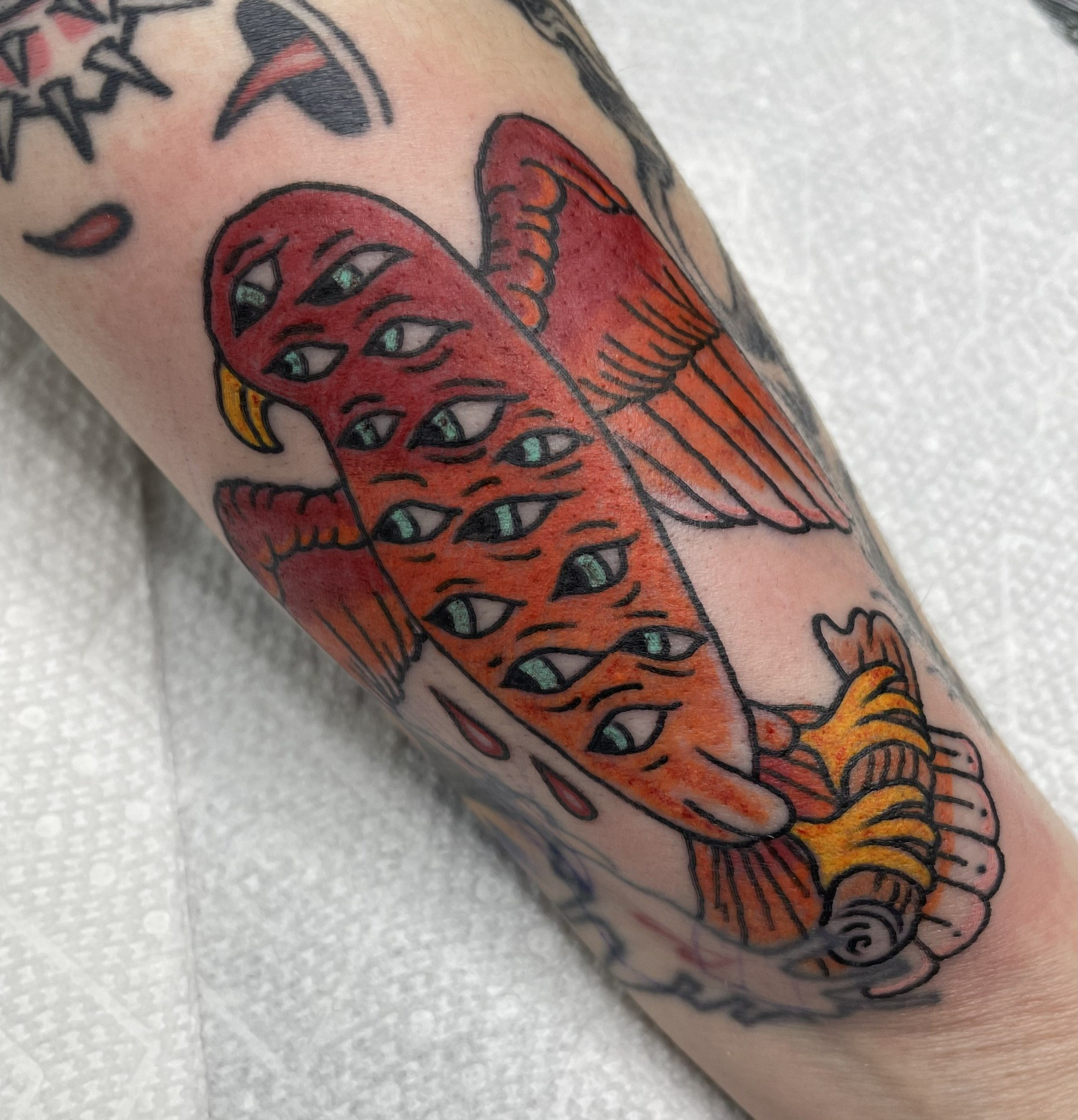 Red multi eyed fish tattoo by Dom at Last Hope Tattoo Company in Toledo