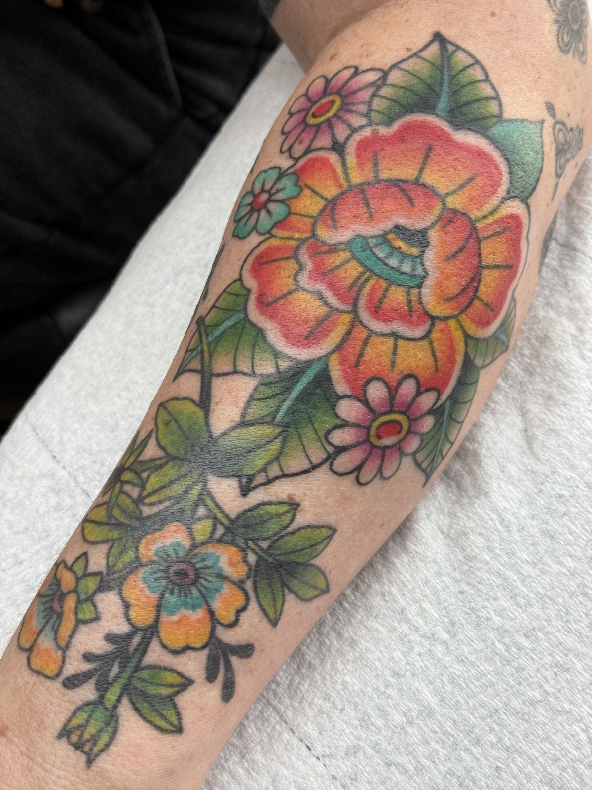 Color floral forearm tattoo by Kara at Last Hope Tattoo Company in Toledo